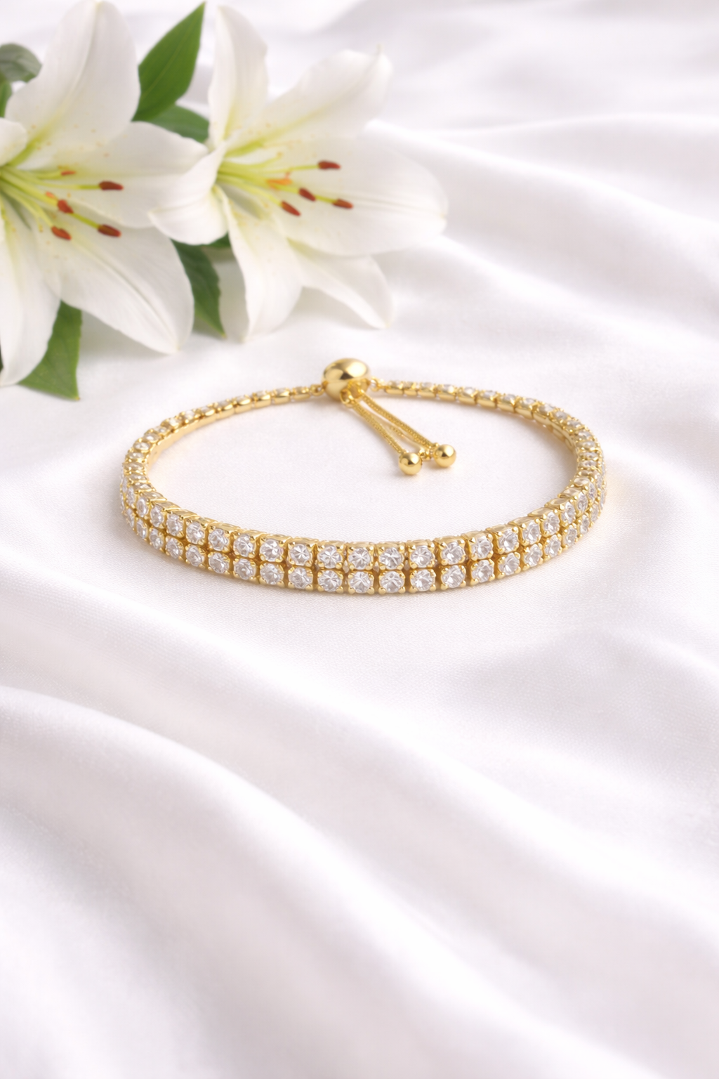 Double Row Diamond-Studded Gold Bracelet with Tassel Chain